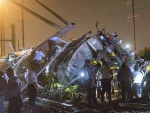 Rescue workers rummage through the wreck of the train to find survivors. Image: Reuters