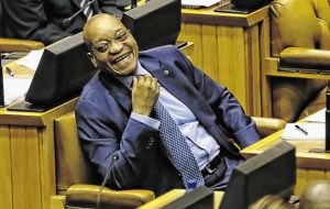 President Zuma cannot help smiling as the opposition digs into his SONA. Image: News24