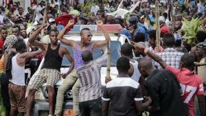 Demonstrators dance for joy on the streets in Burundi as news of the coup spreads. Image: APP